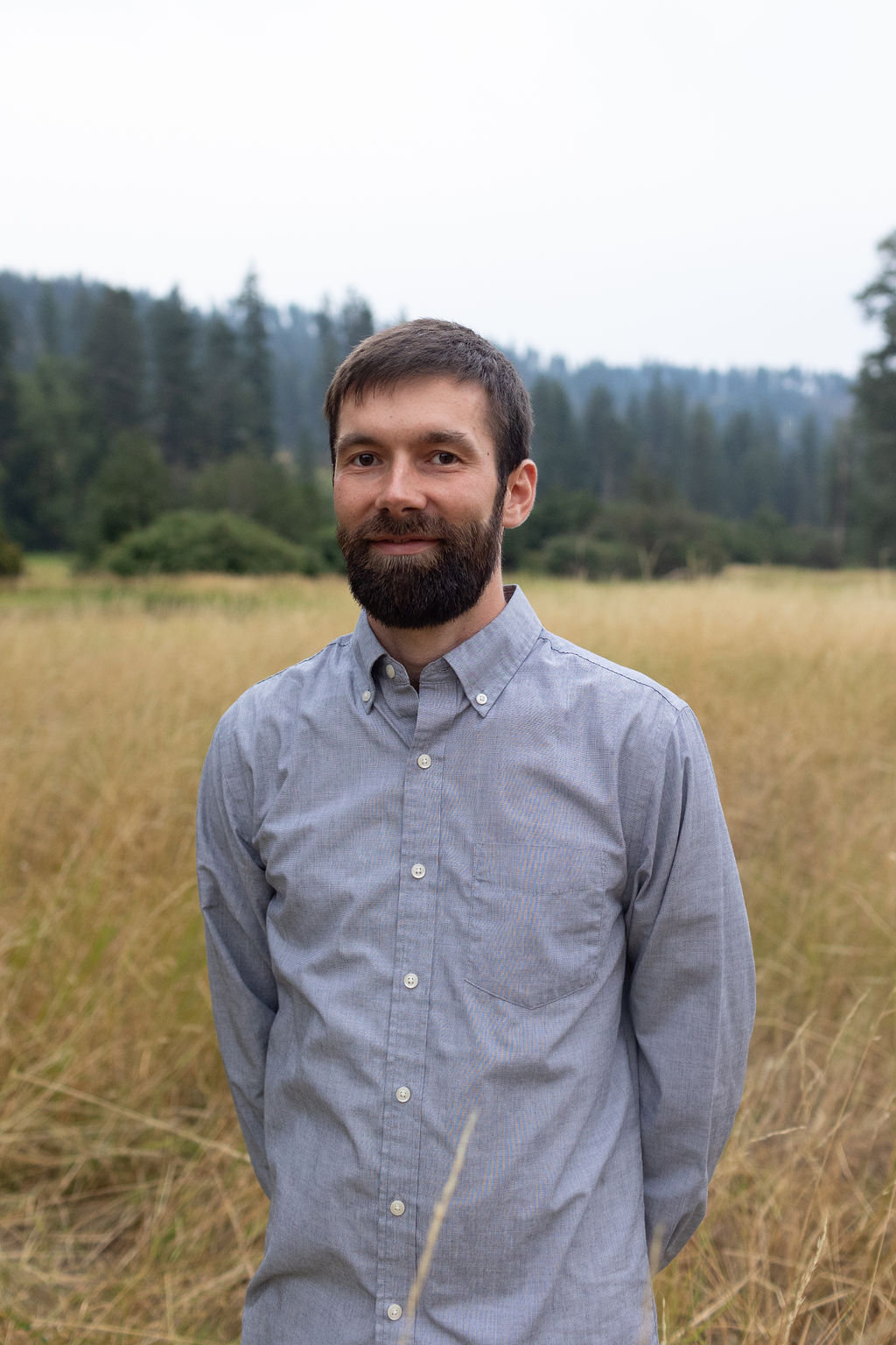 Portrait of the founder of Acumen Bookkeeping & Consulting LLC, a bearded professional in a light-blue oxford shirt.